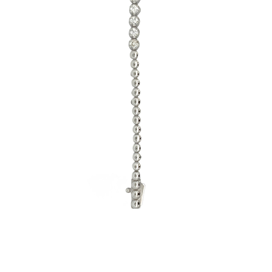 Woman wearing a delicate 14k gold bracelet with diamond