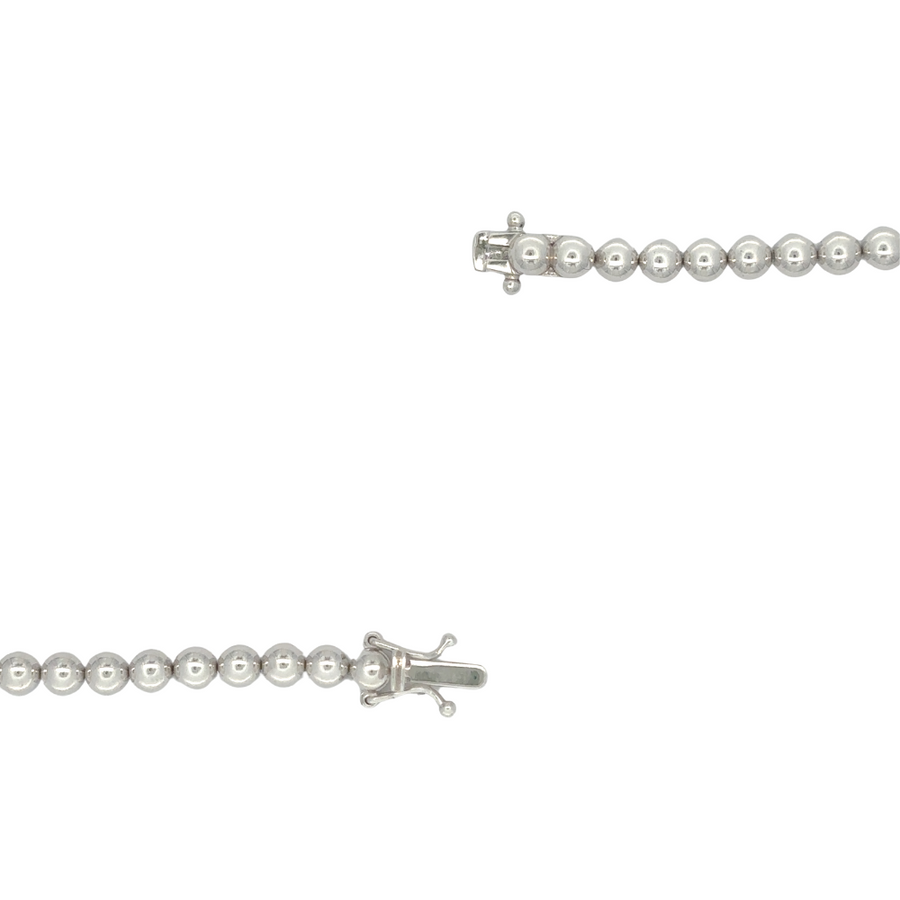 Woman wearing 14k gold diamond bracelet with formal attire