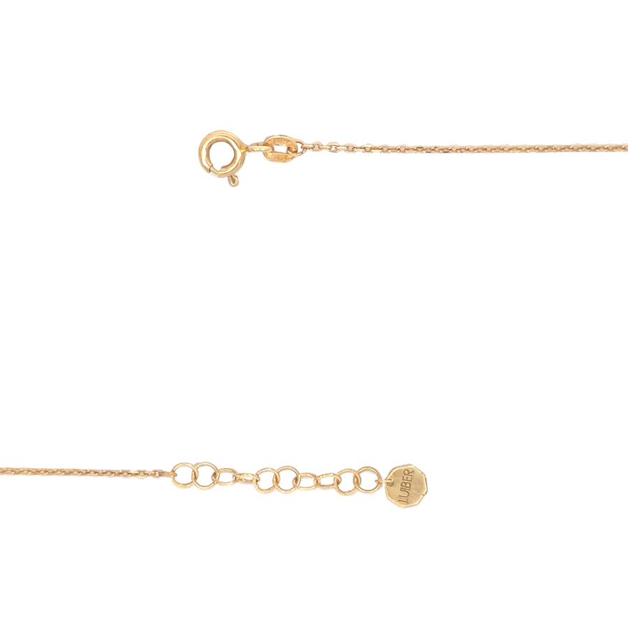 Close-up of 14k gold heart bracelet on white background
