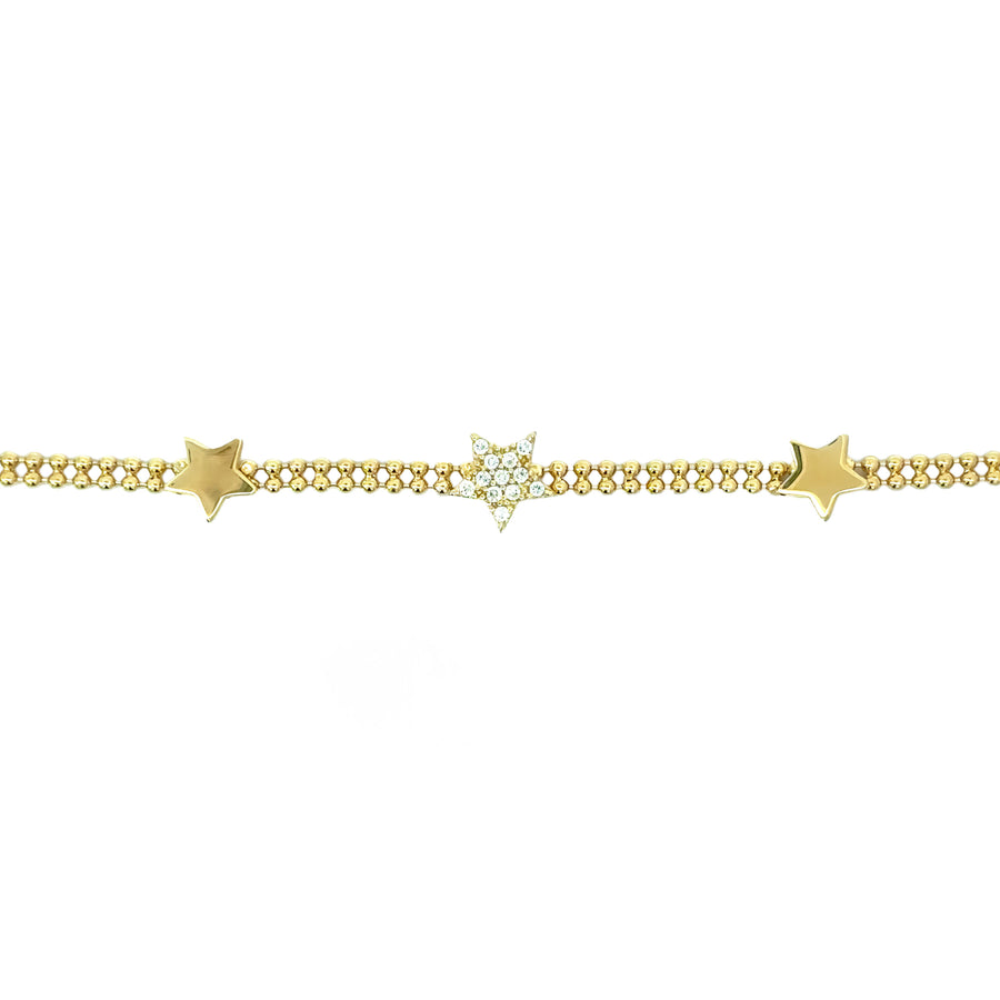 Close-up of 14k gold bracelet featuring triple star design