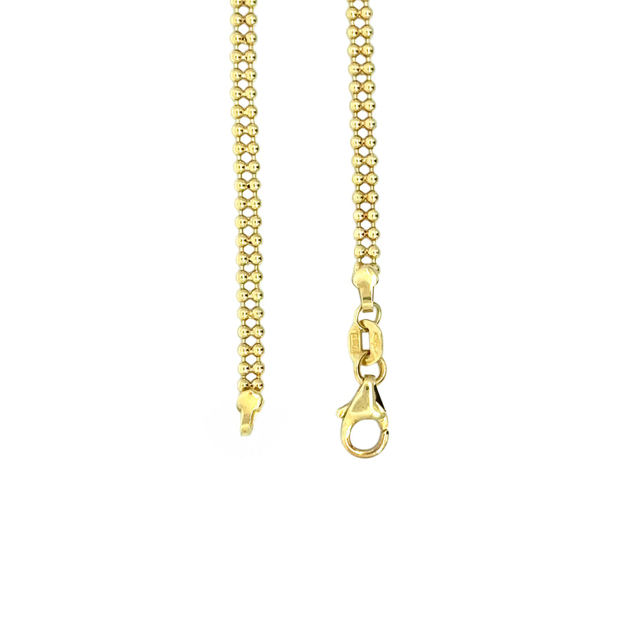 Woman wearing 14k gold star bracelet with sparkling CZ center