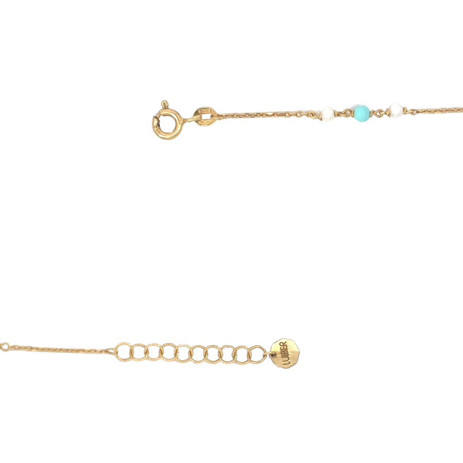 Close-up of mini heart on gold bracelet