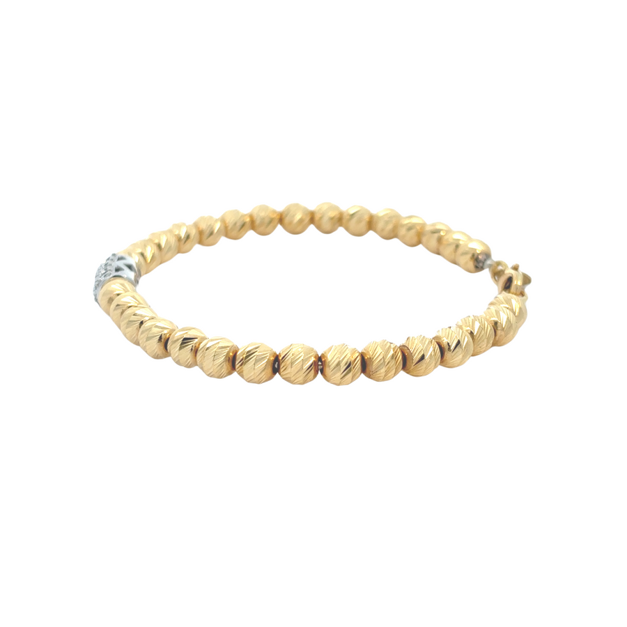Bracelet detail showing gold texture and diamond sparkle