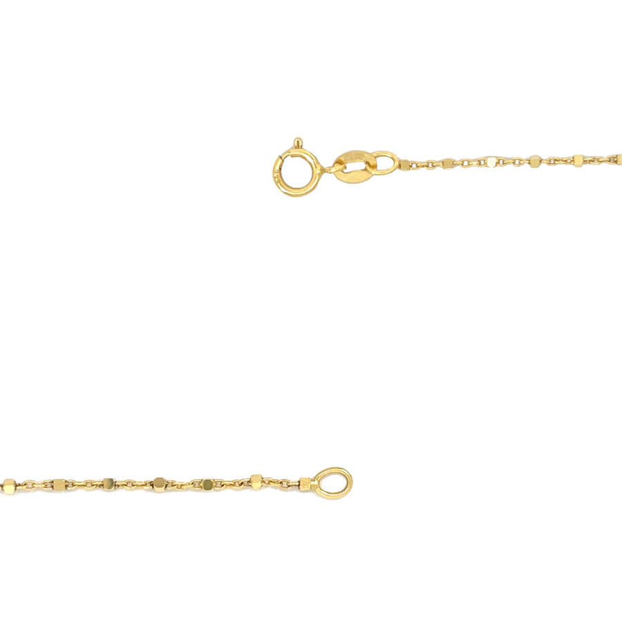 14k gold chain layered with other fine jewelry on a woman’s neck