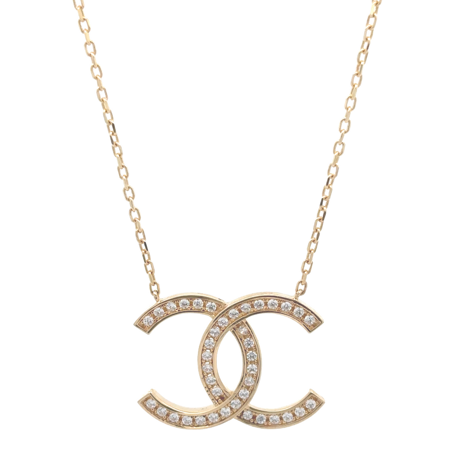 14k gold chain with sparkling CZ stones laid flat on a white background