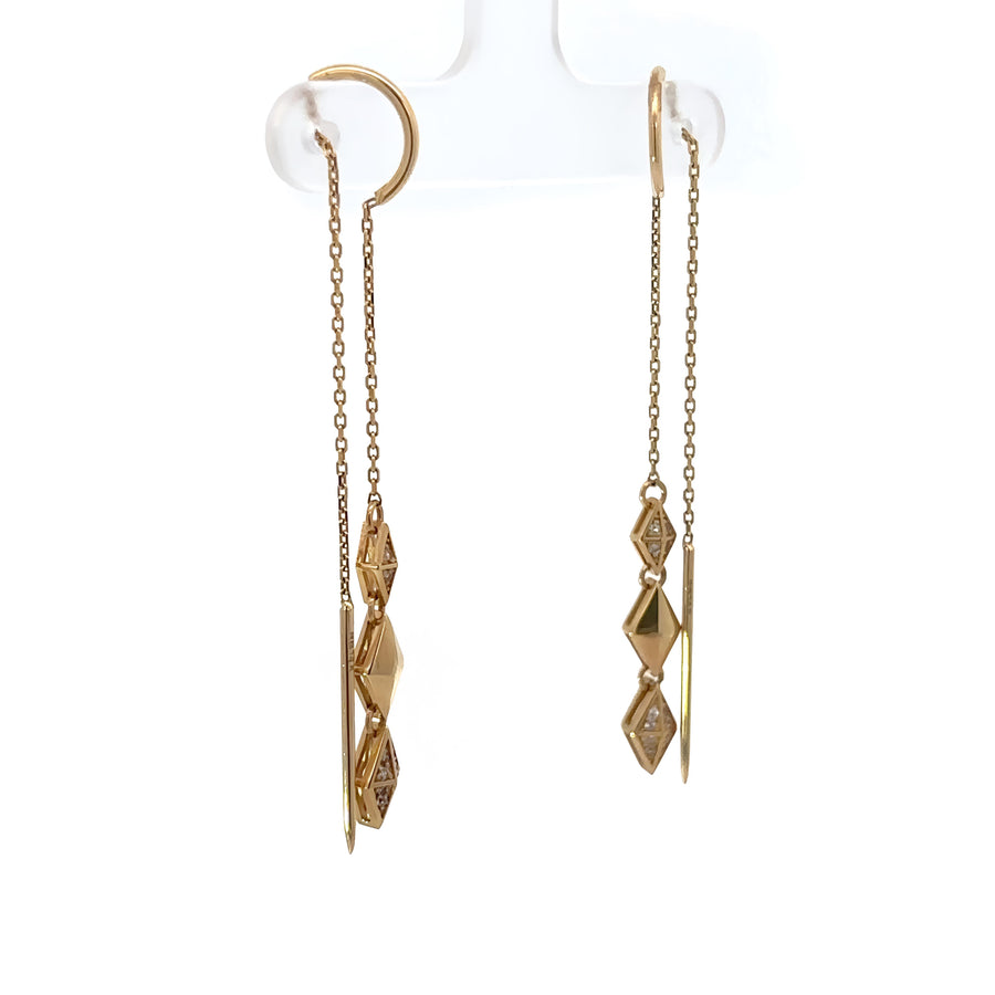 Side view of polished gold stud earrings