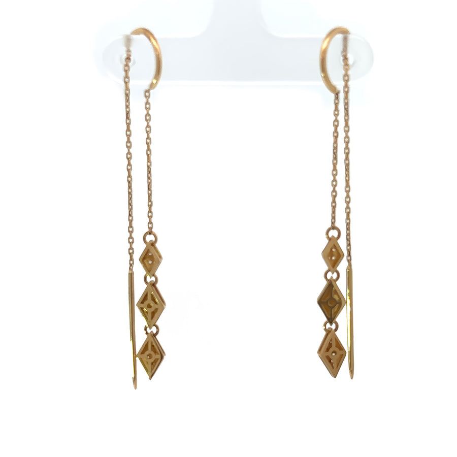 Woman wearing classic 14k gold earrings