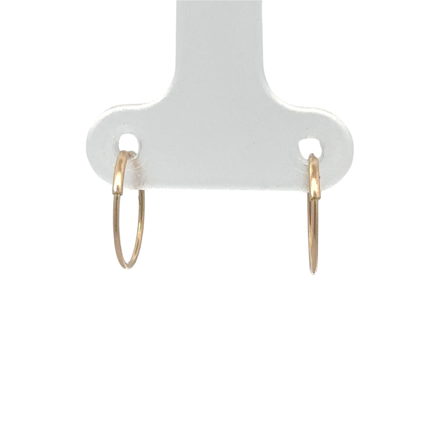 Woman wearing minimalist 14k gold studs