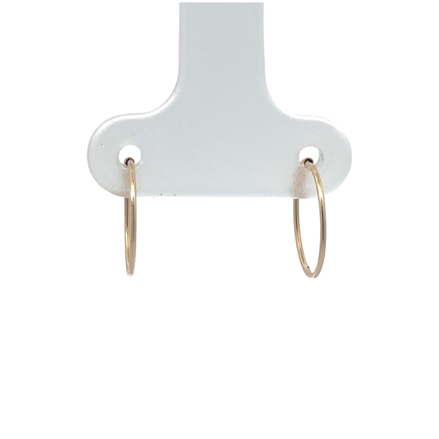 Pair of 14k gold classic stud earrings displayed on white