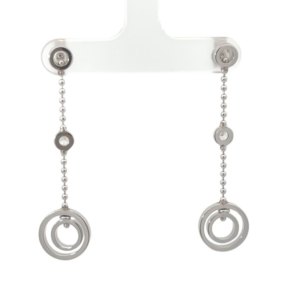 Woman wearing elegant gold dangle earrings with diamonds