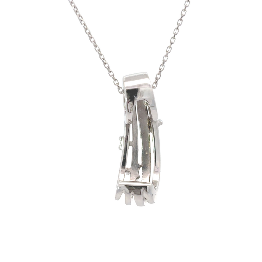 Pendant and earrings set laid flat with light reflections