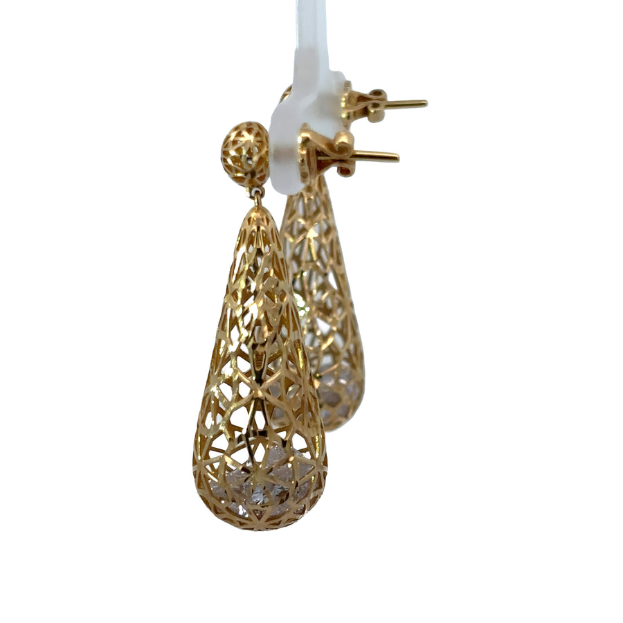 Woman wearing elegant 14k gold diamond earrings
