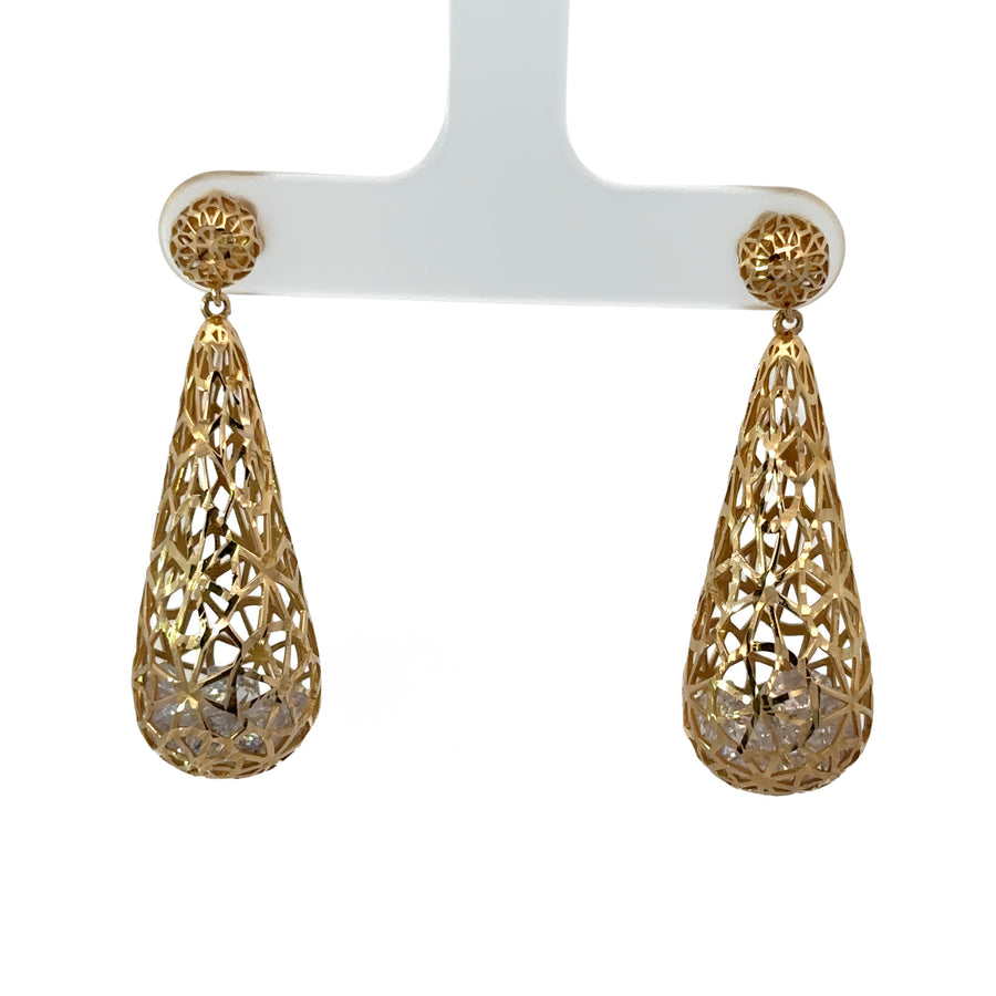 Close-up of diamond-studded 14k gold earrings