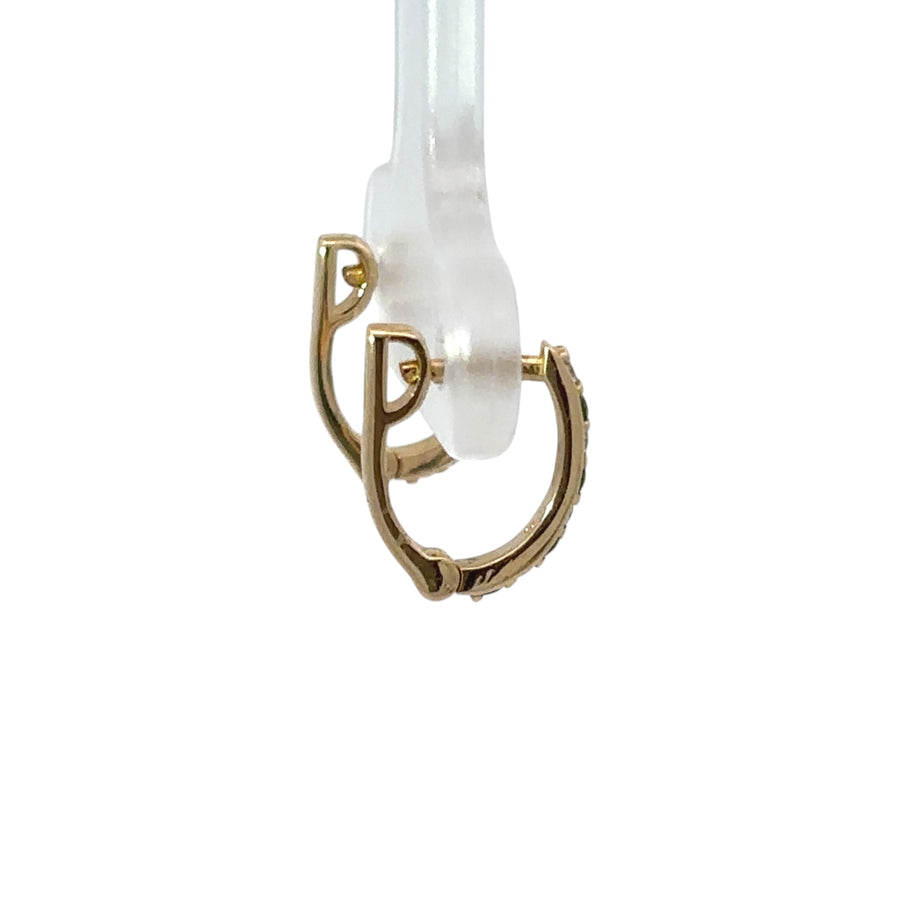 Close-up of 0.08 CT diamond studs in yellow gold setting