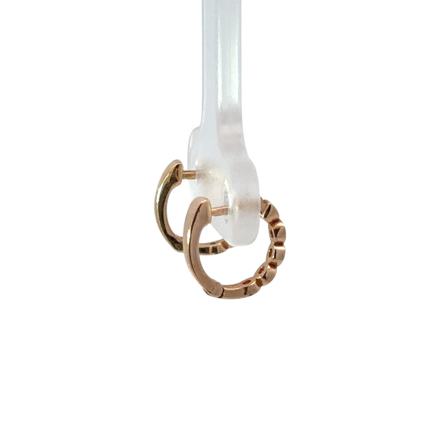 Baby girl wearing 14k gold and diamond stud earrings