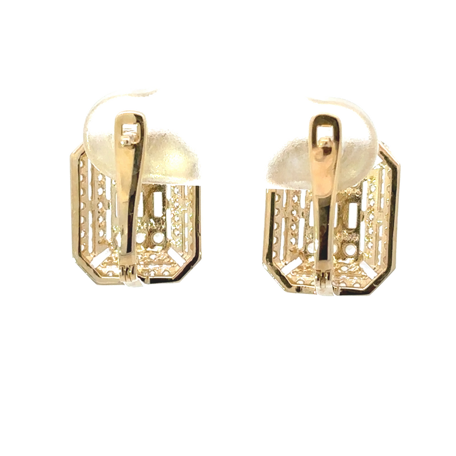 Elegant 14k gold earrings displayed on a jewelry stand