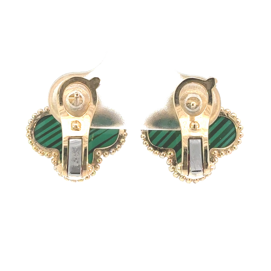Woman wearing a 14k gold earring with elegant outfit