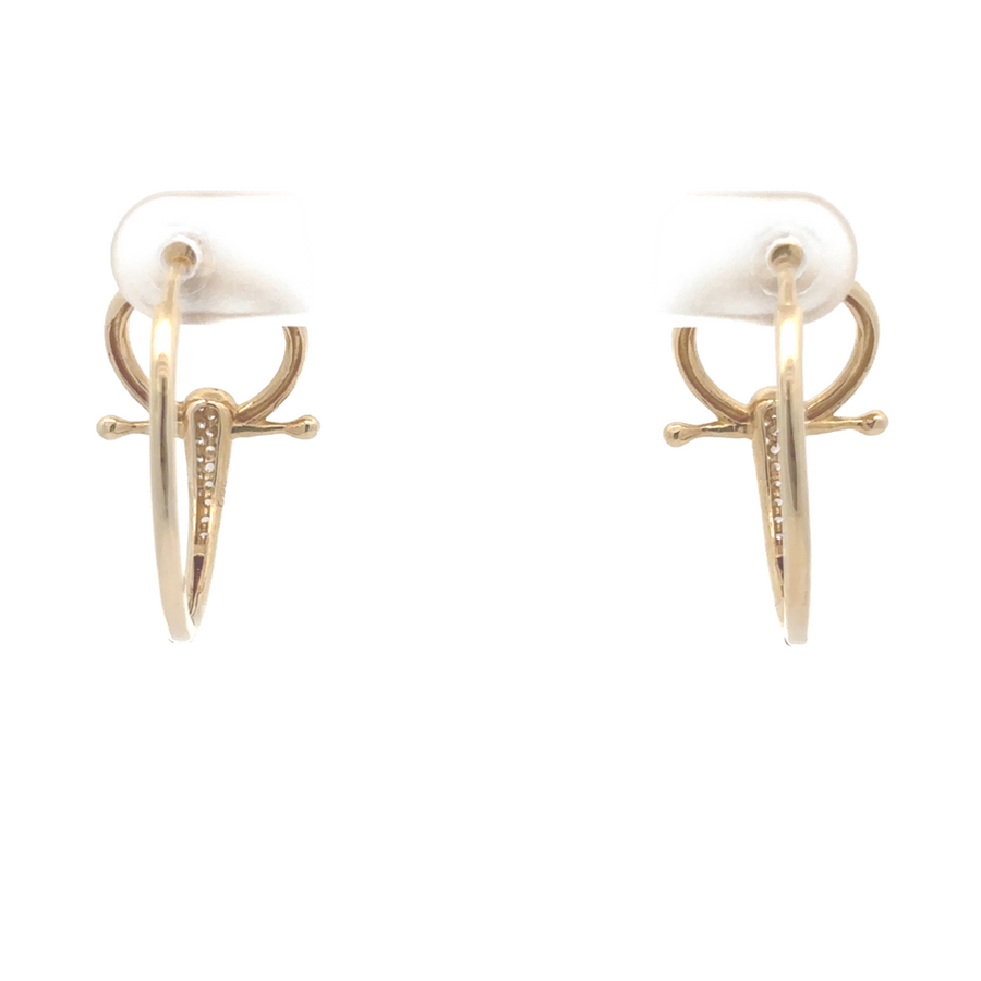 Woman wearing simple 14k gold earrings with a casual blouse