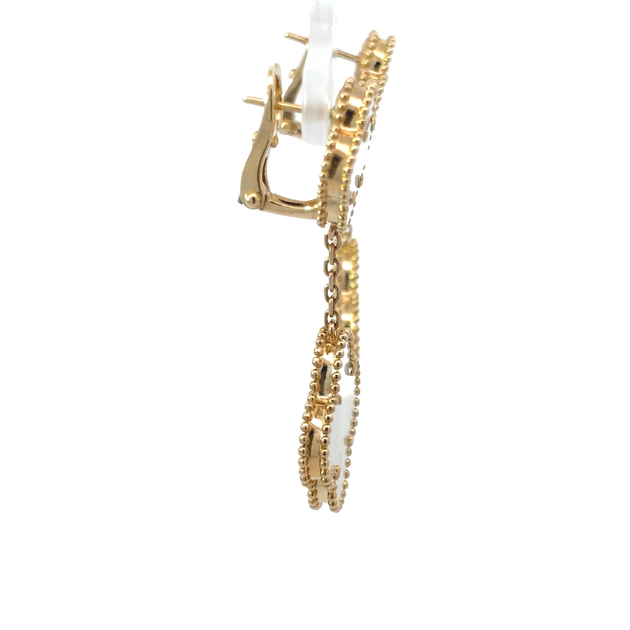Woman wearing elegant 14k gold earrings with hair tucked back
