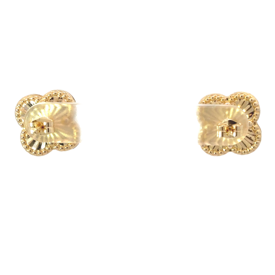 Woman wearing 14k gold earrings with casual outfit