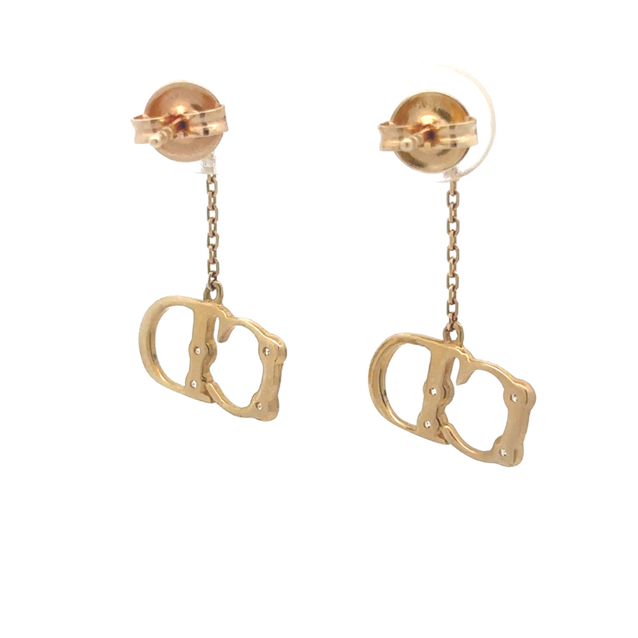 Woman wearing 14k gold earrings with formal attire