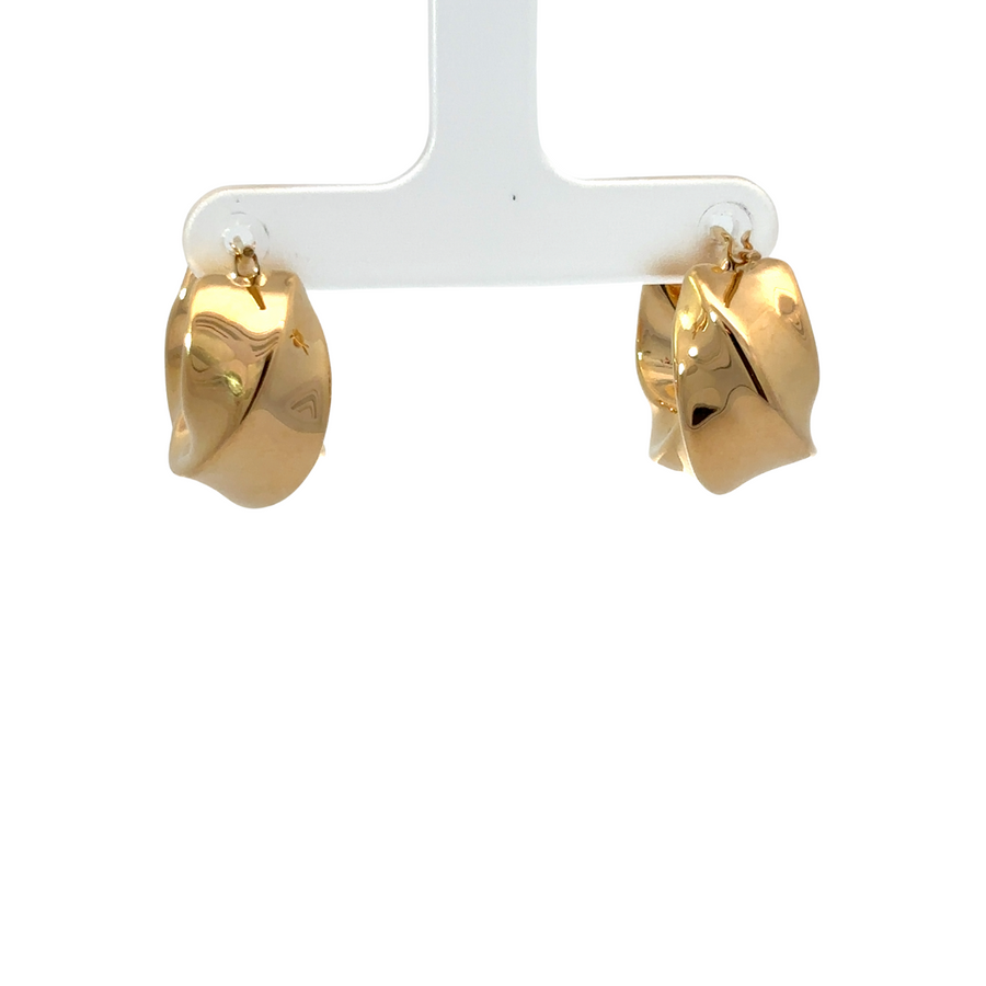 Close-up of polished 14k gold women’s earrings