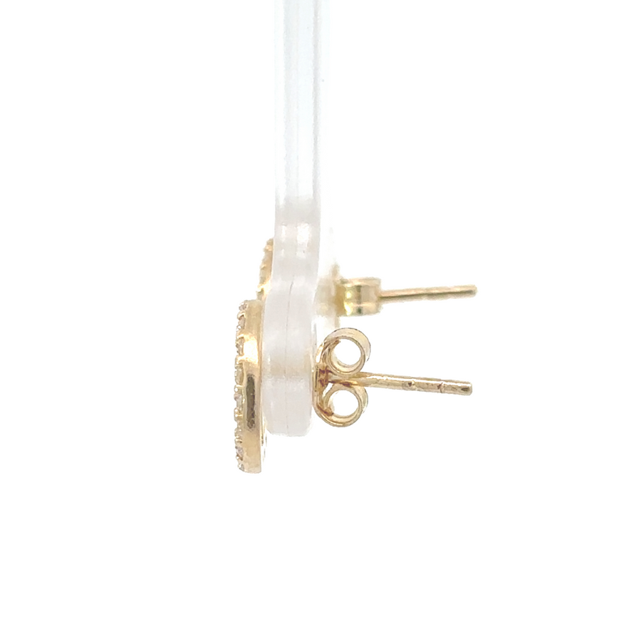 Woman wearing sparkling 14k gold earrings with CZ from side profile