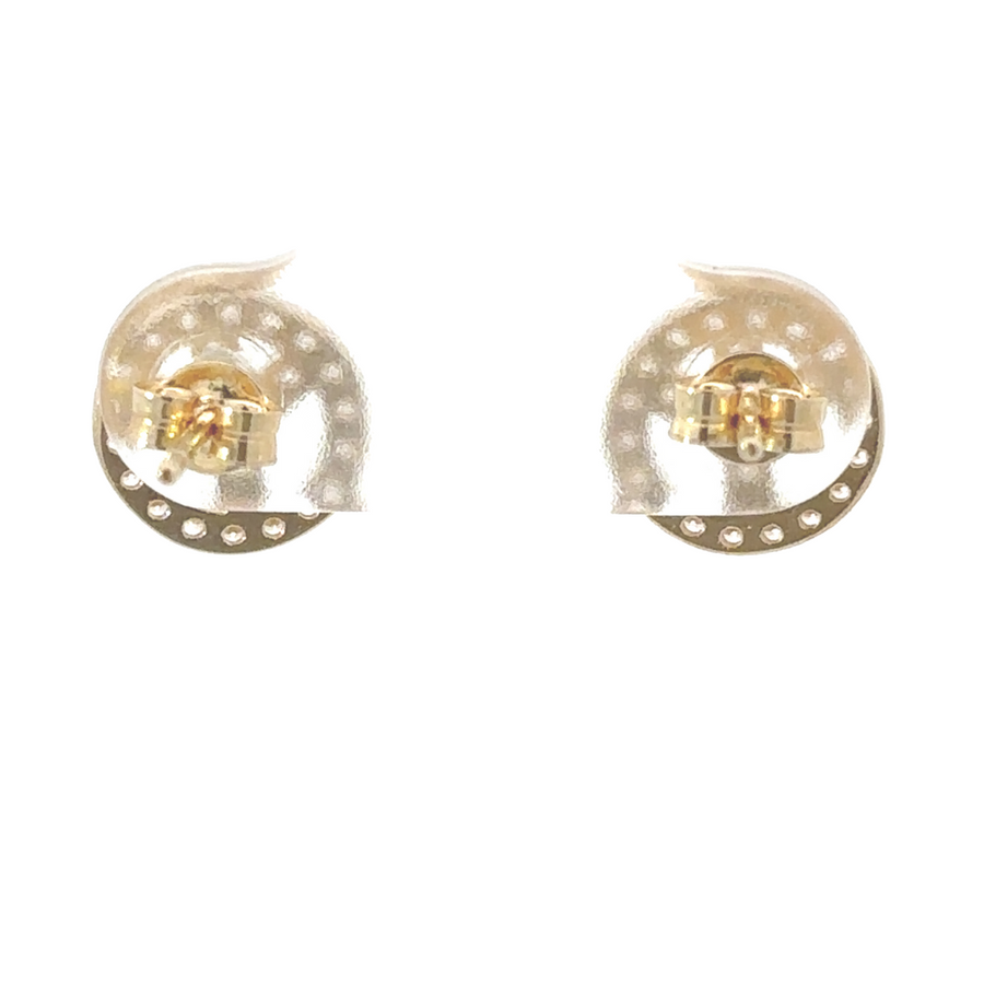 Elegant gold earrings displayed on white velvet stand