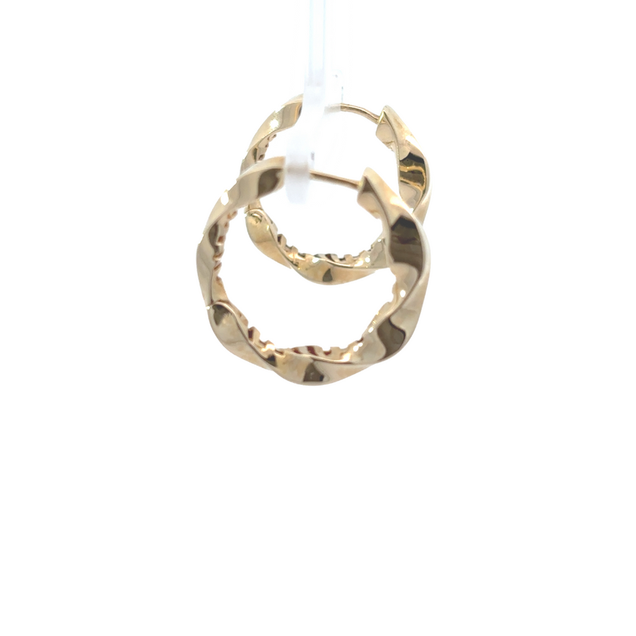 Woman wearing timeless 14k gold earrings with a sleek finish