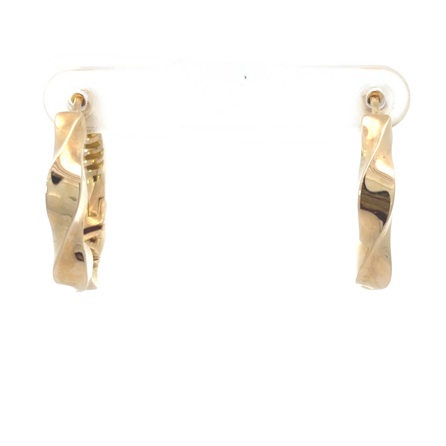 Pair of classic gold earrings for women displayed flat-lay style