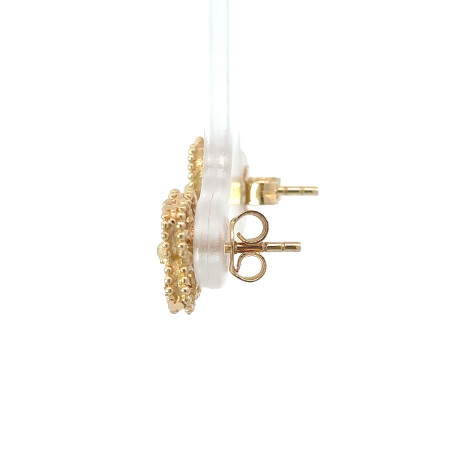 Close-up of gold earrings showing the radiant finish