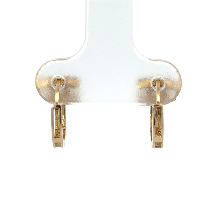 Pair of simple 14k gold earrings displayed in jewelry box