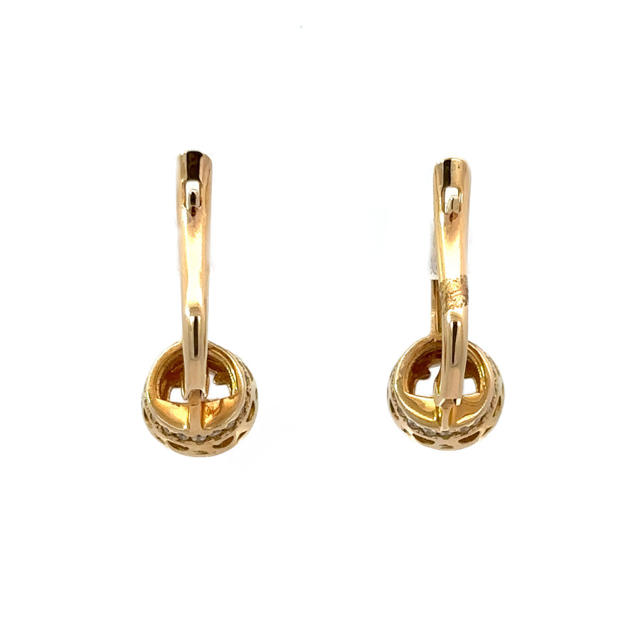 Classic gold earrings displayed in a velvet jewelry box
