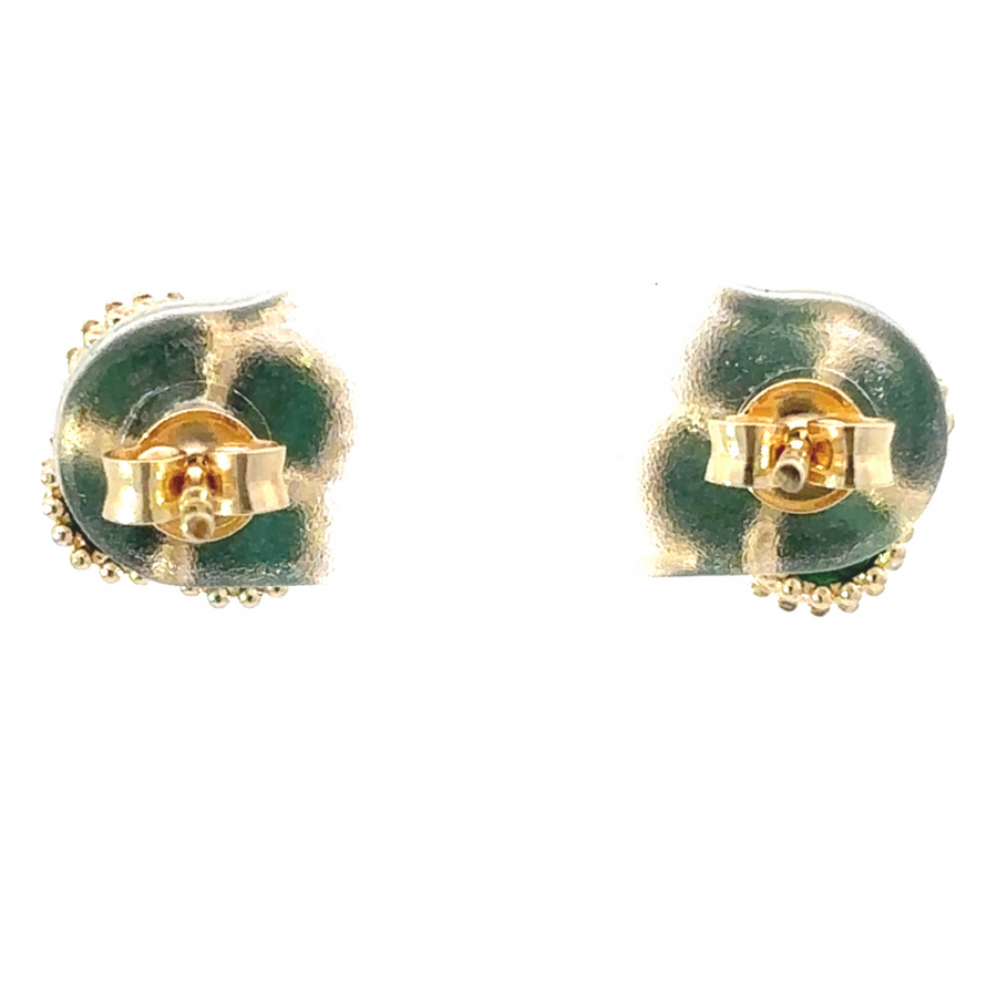 Earrings displayed on a jewelry stand with soft lighting