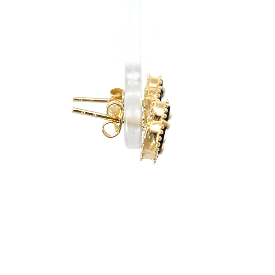 Close-up of one 14k gold earring showing black accent detail