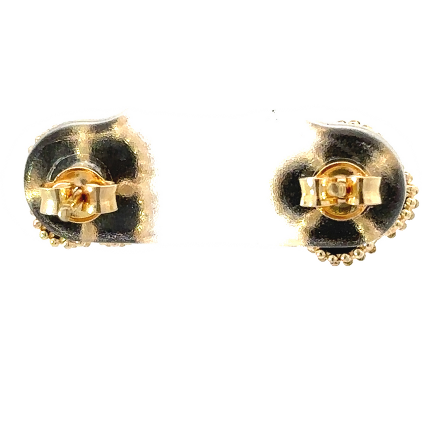 Pair of 14k gold earrings styled next to minimalist jewelry