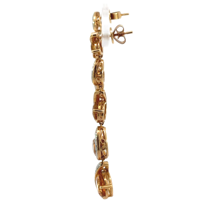 Close-up of citrine and diamond earrings in gold