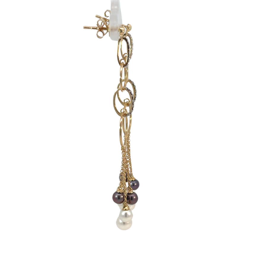 Elegant women’s earrings featuring diamonds and pearls on gold setting