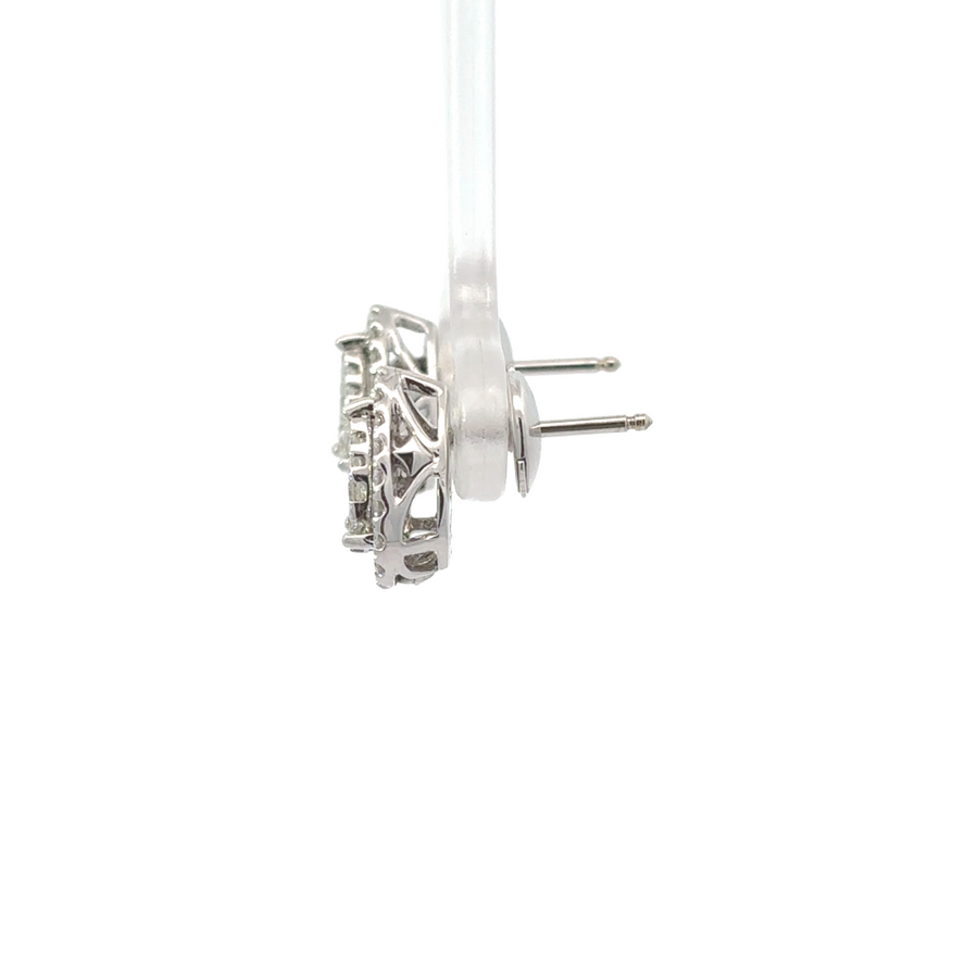Elegant pair of 14k gold diamond earrings on a velvet display