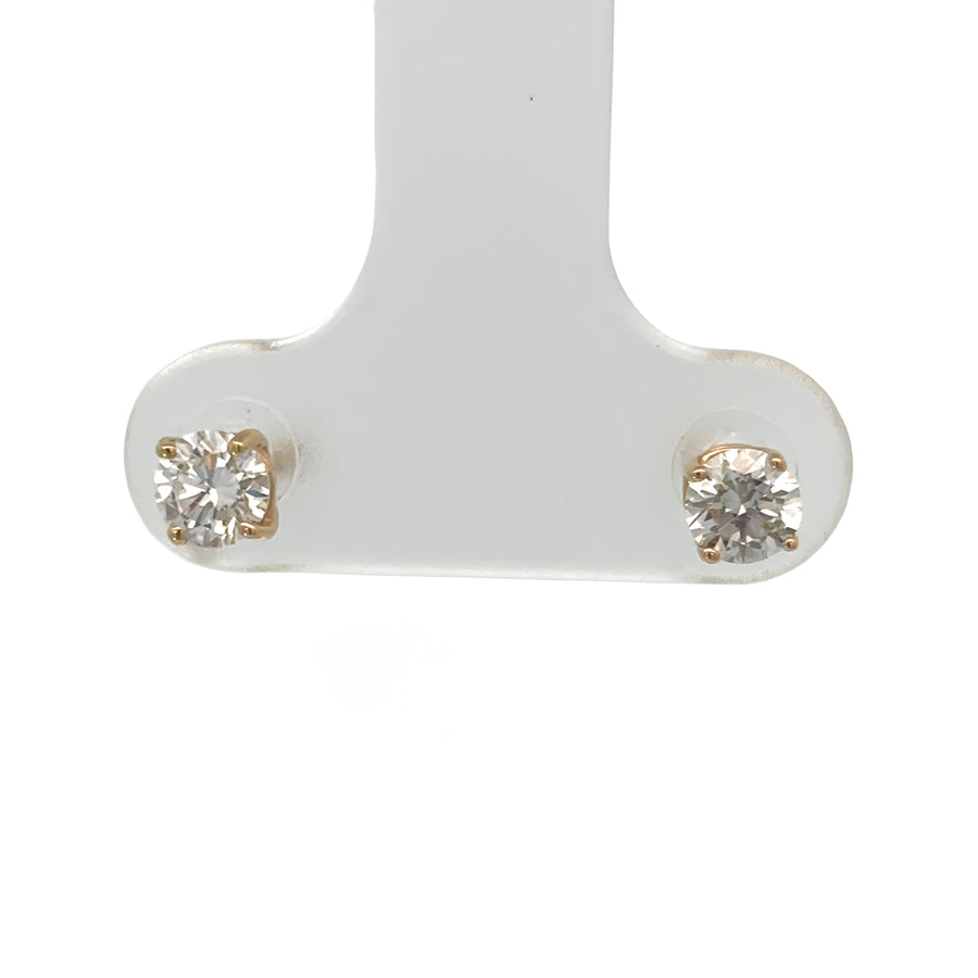 Woman wearing 14k gold earrings with lab-grown diamonds