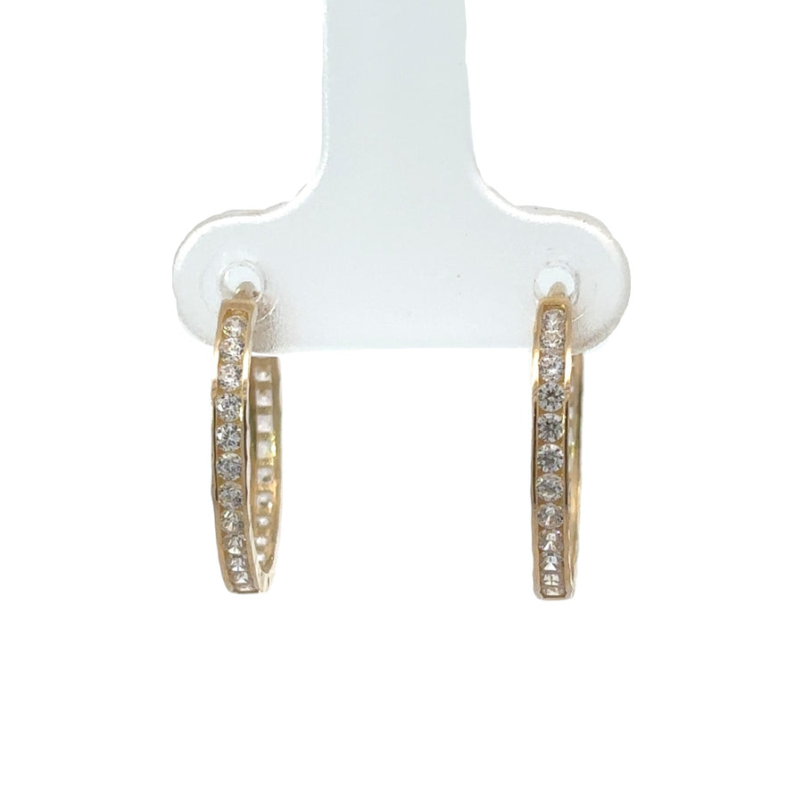 Close-up of 14k gold small hoop earrings with faceted cubic zirconia