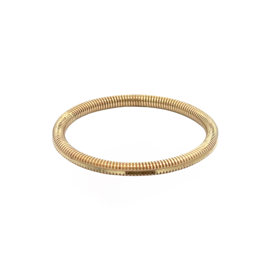 Close-up of textured gold ring with faceted surface