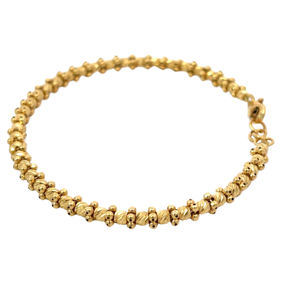 Elegant gold bangle with textured design and 5.8 cm diameter