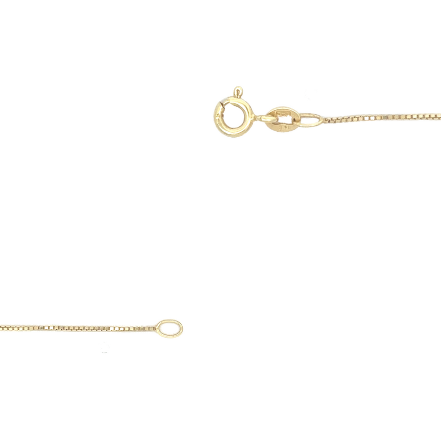 Slim gold chain draped over a jewelry box for display