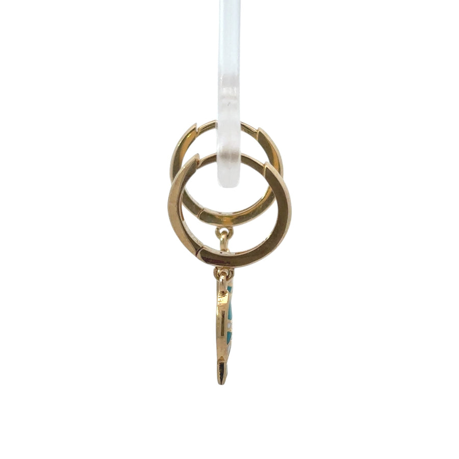 Baby wearing 14k gold fish design huggie earrings