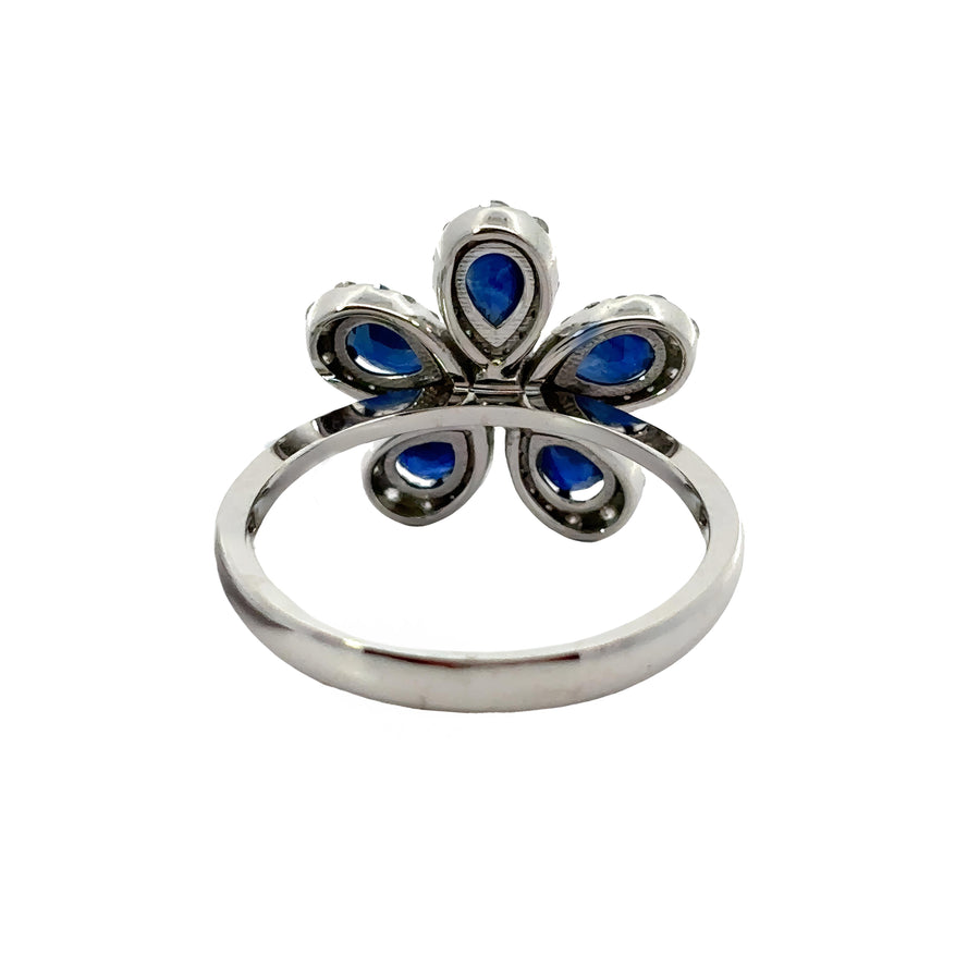 Side view of 14k gold flower ring showcasing gemstone settings
