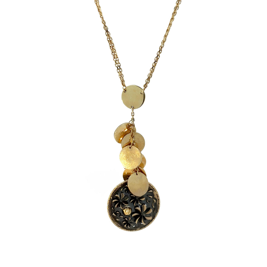 Close-up of circular pendant on 14k gold necklace