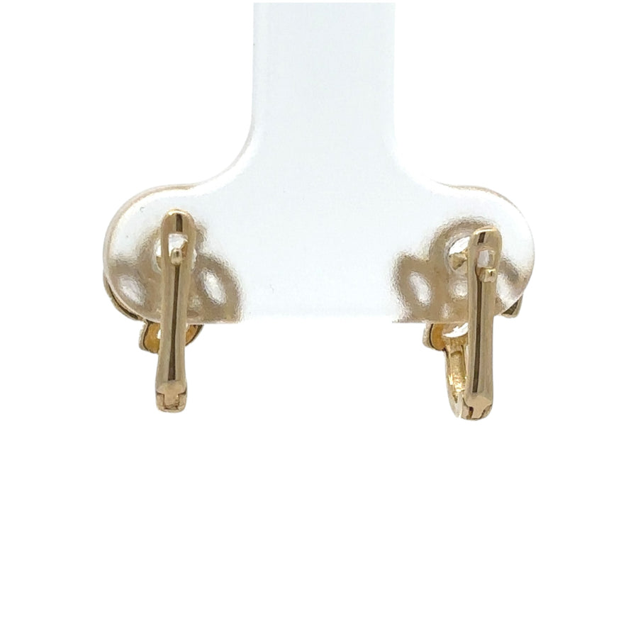 Close-up of flower-shaped 14k gold earrings