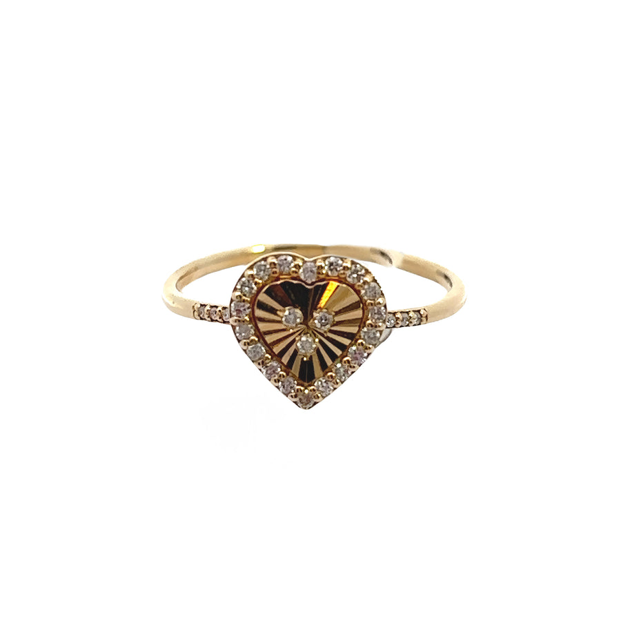 Woman wearing a 14k gold heart diamond ring on finger