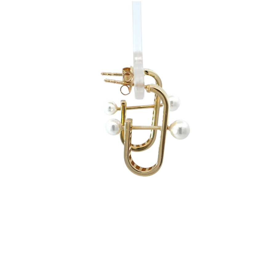 14k gold hoop earrings with pearl on a neutral background, emphasizing the elegant design